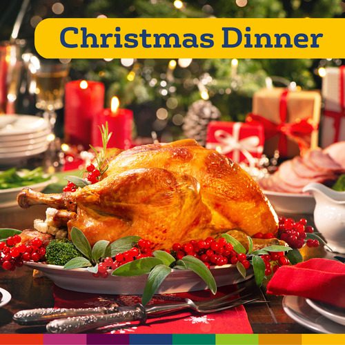 Um peru assado em uma travessa decorada com ervas e frutas vermelhas sobre uma mesa festiva com decorações natalinas de Manchester e presentes embrulhados ao fundo. O texto diz "Jantar de Natal".