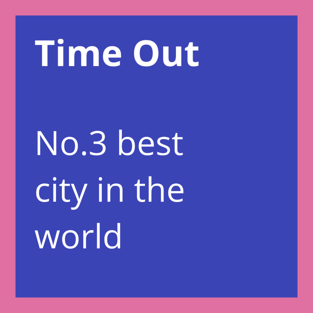 A blue square with the text "Time Out No.3 best city in the world," highlighting Manchester, in white and framed by a pink border.