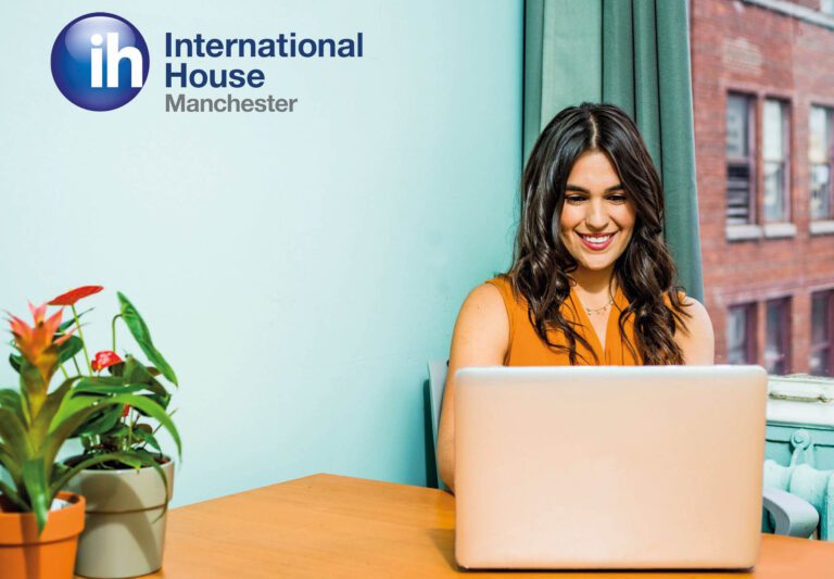 Lady sat at desk working on laptop
